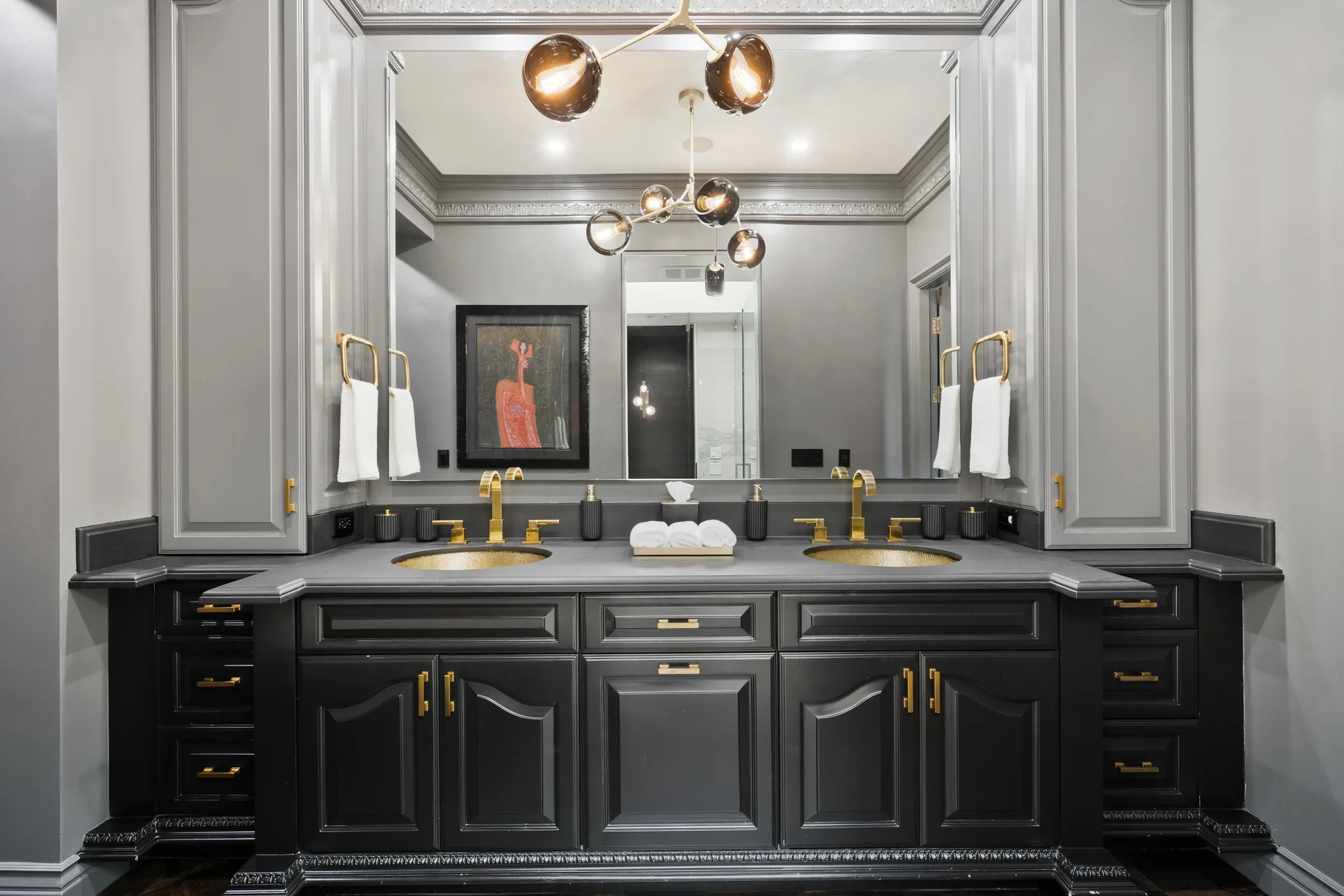 Ensuite double vanity with hammered gold basins, brass taps and smoked-glass globe pendants