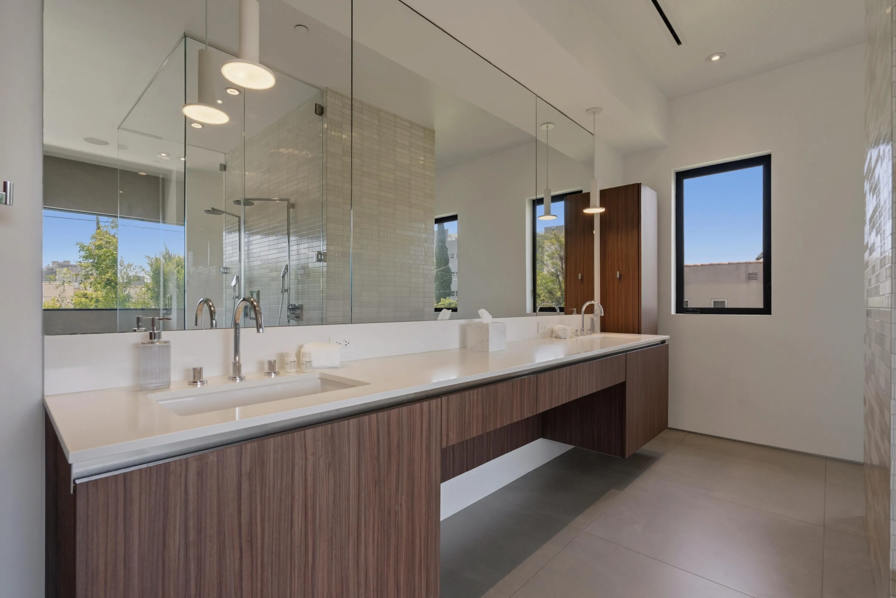 Ensuite bath with double floating walnut vanity, full-width mirror and glass walk-in rain shower