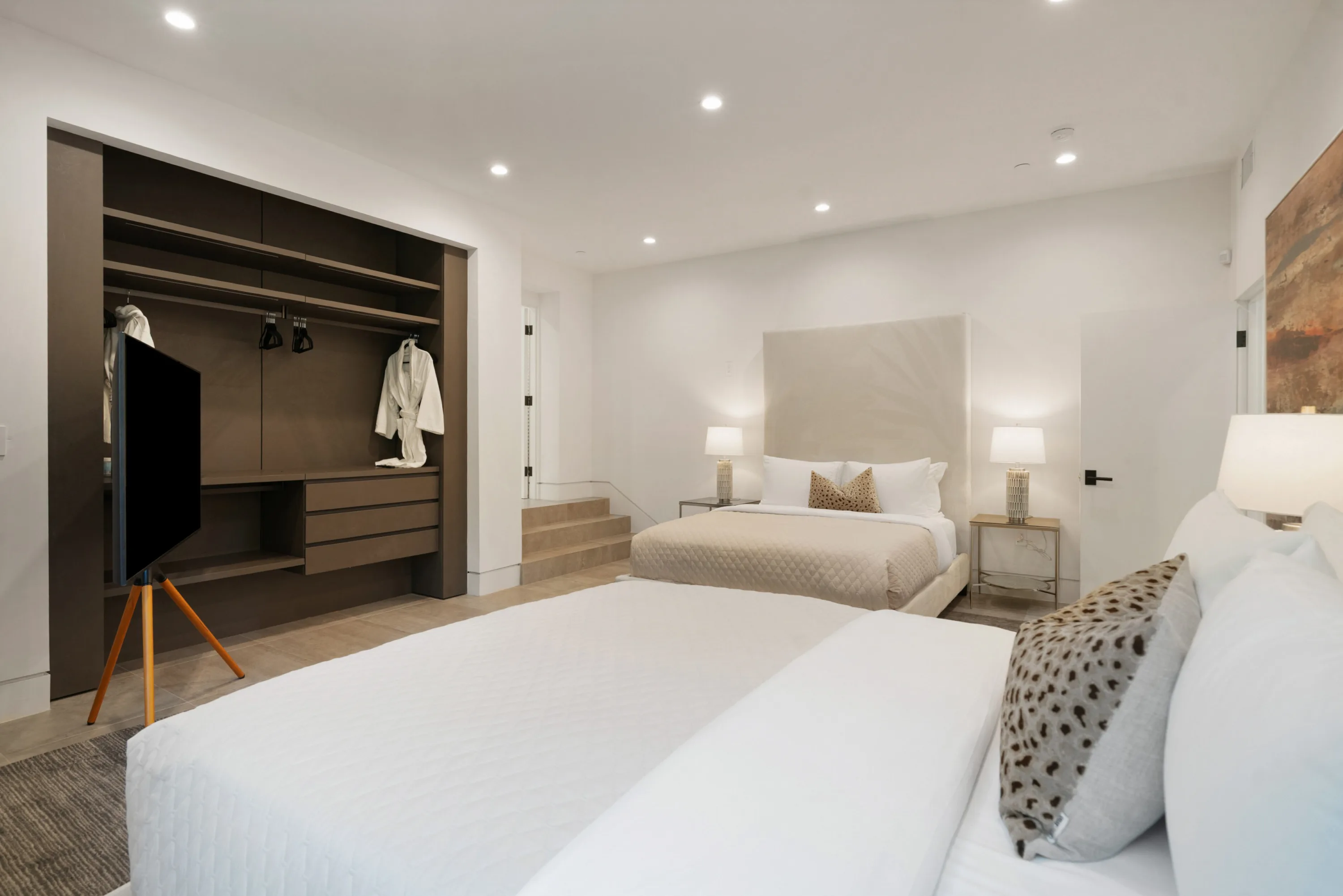 Split-level bedroom sleeping four, with built-in wardrobe and steps up to the door
