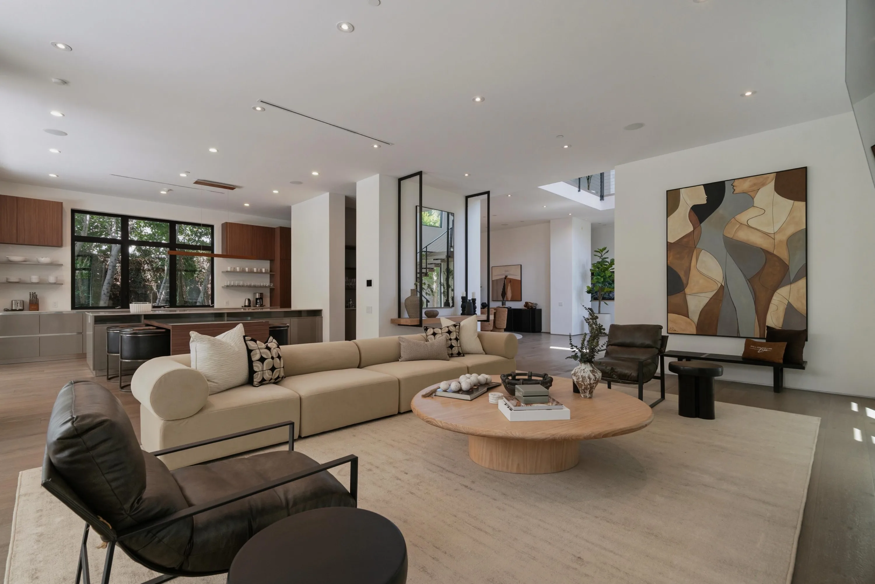 Great room looking across the sectional to the walnut kitchen island and a large abstract canvas
