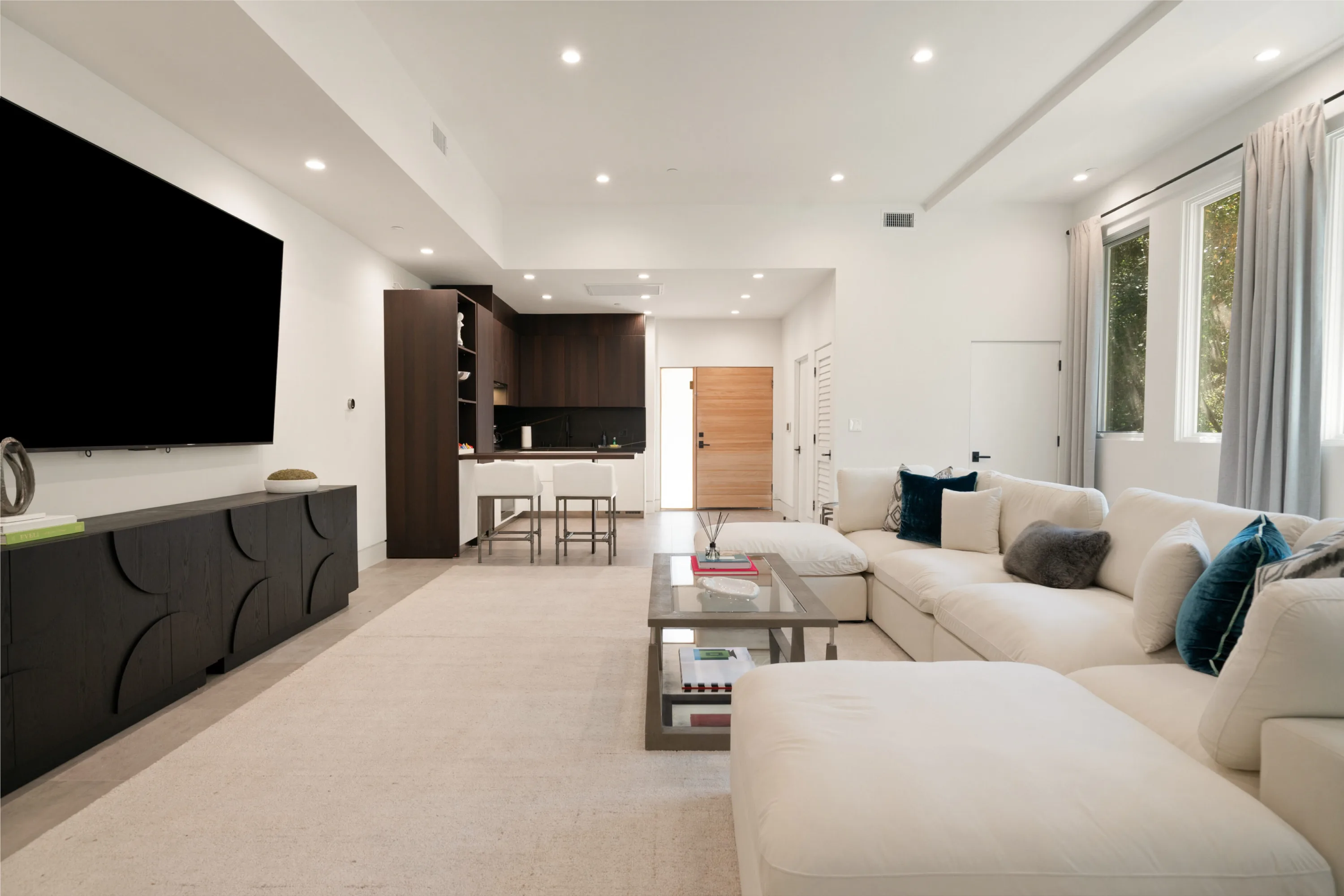 Open lounge and kitchenette running to the oak entry door, seating for a crowd