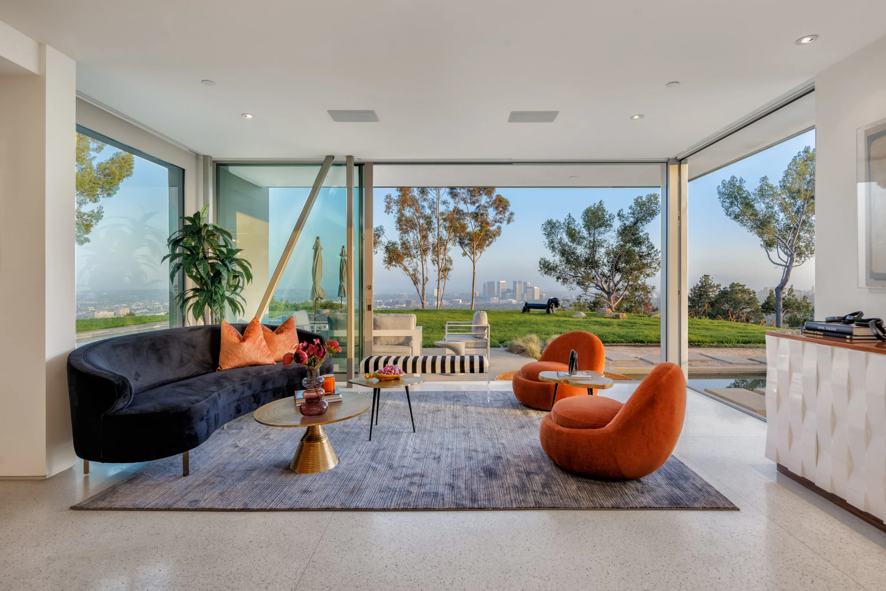 Glass corner of the great room opens to the lawn and Century City skyline in the distance