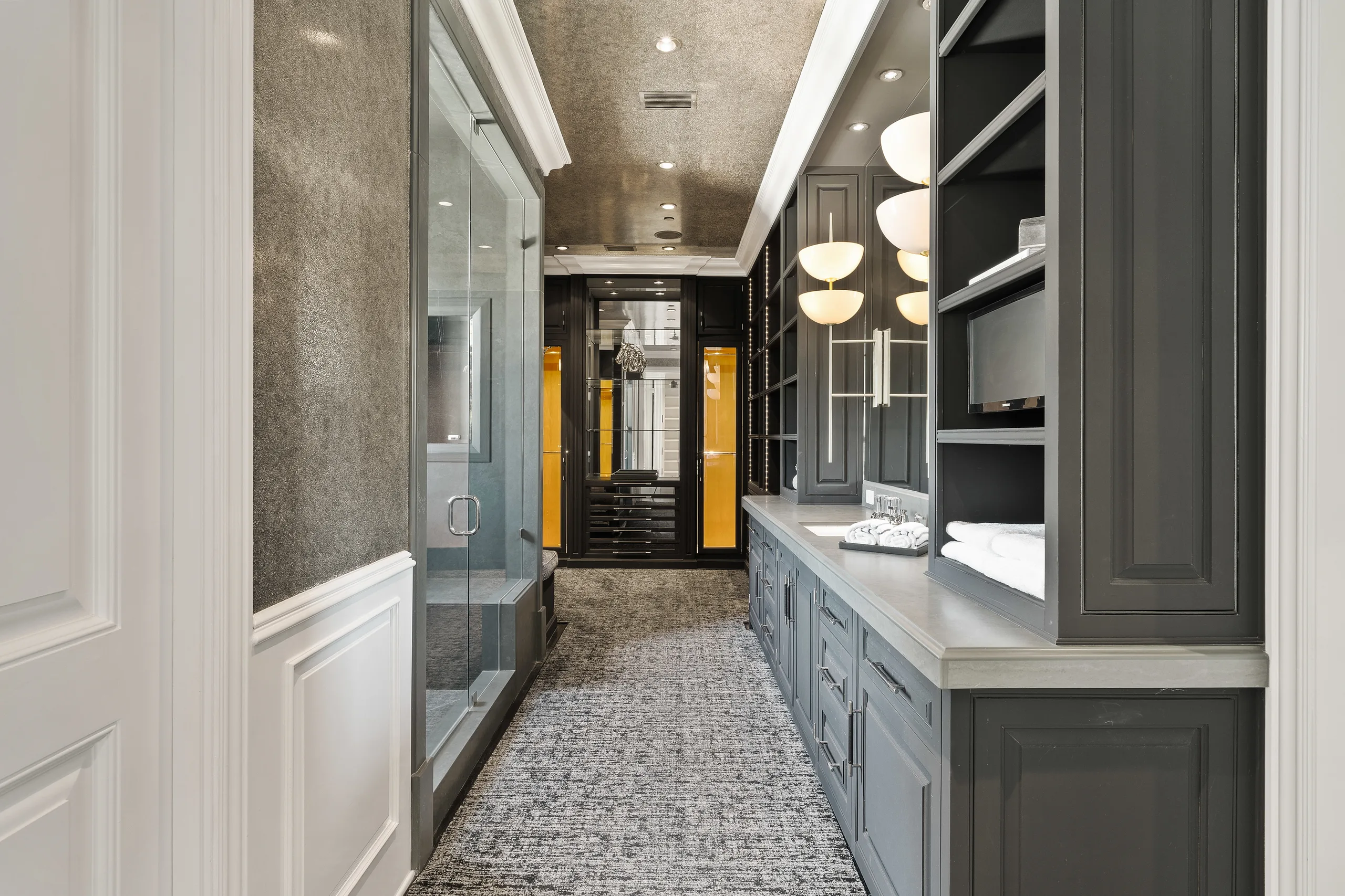 Charcoal-toned second bath and dressing corridor with steam shower, double vanity and sculptural pendant lights