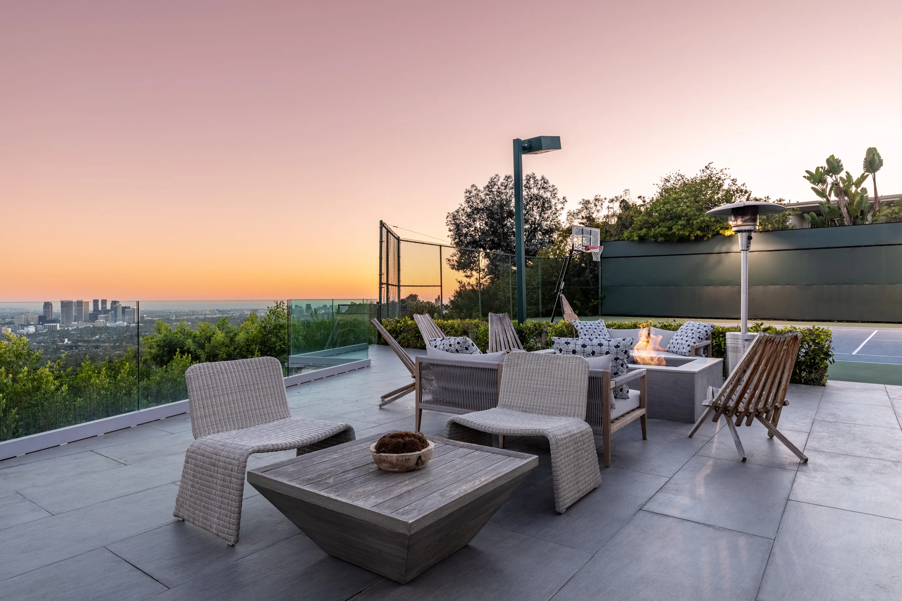 Fire pit lounge on the view terrace at sunset, Century City skyline on the horizon