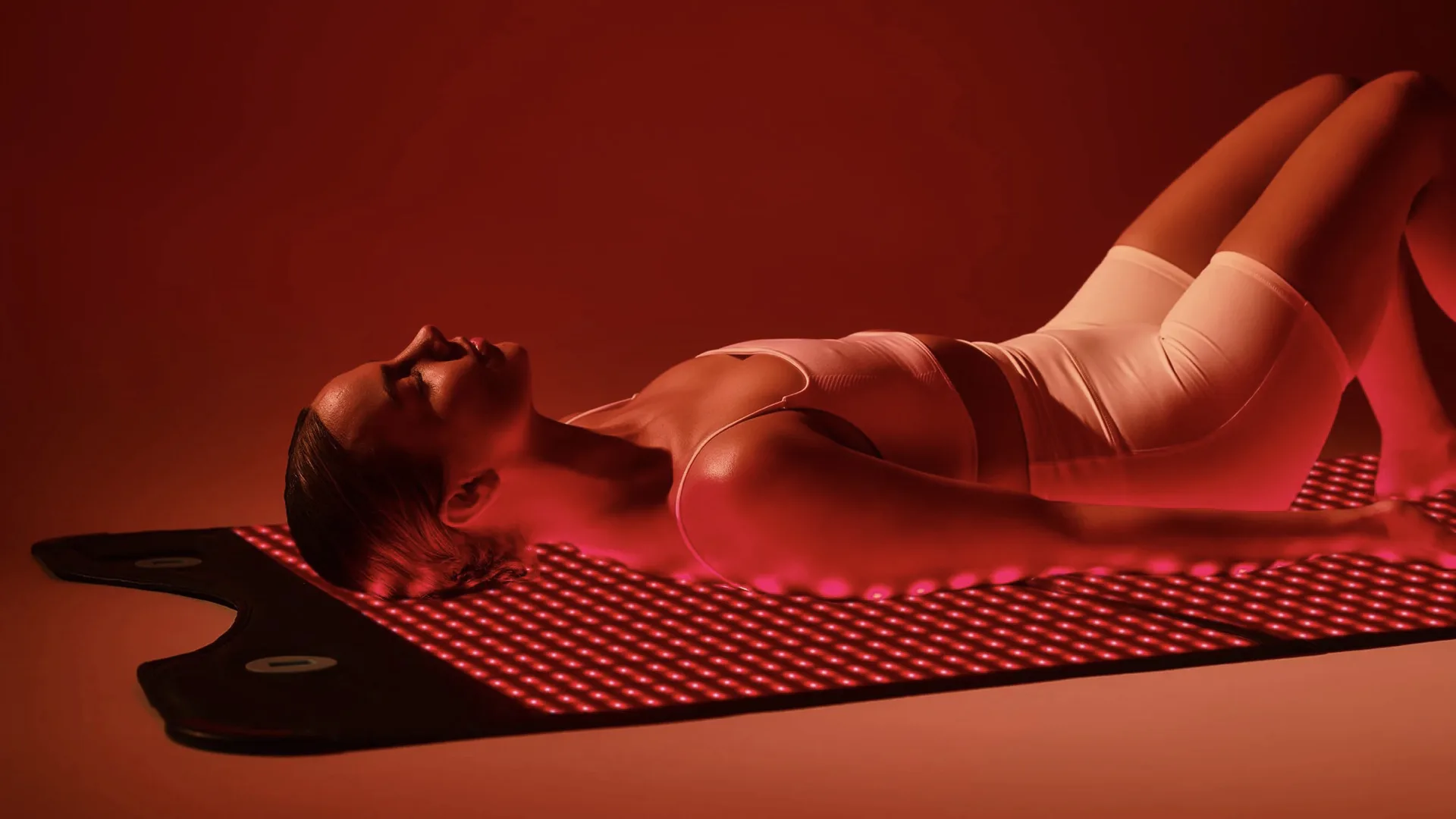 Woman relaxing on a HigherDOSE Go Mat during a private wellness experience at a luxury Los Angeles villa