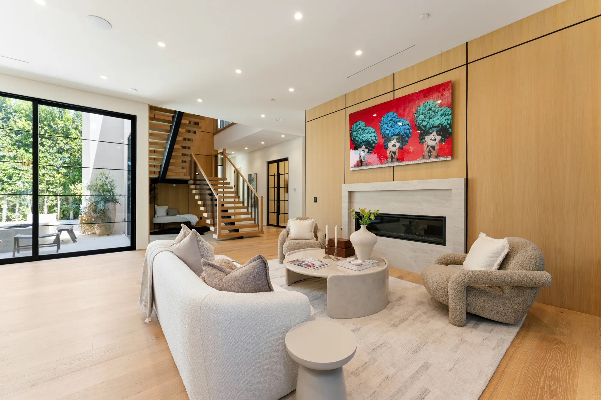 Formal lounge with linear fireplace set into oak panelling and bold red portrait artwork above