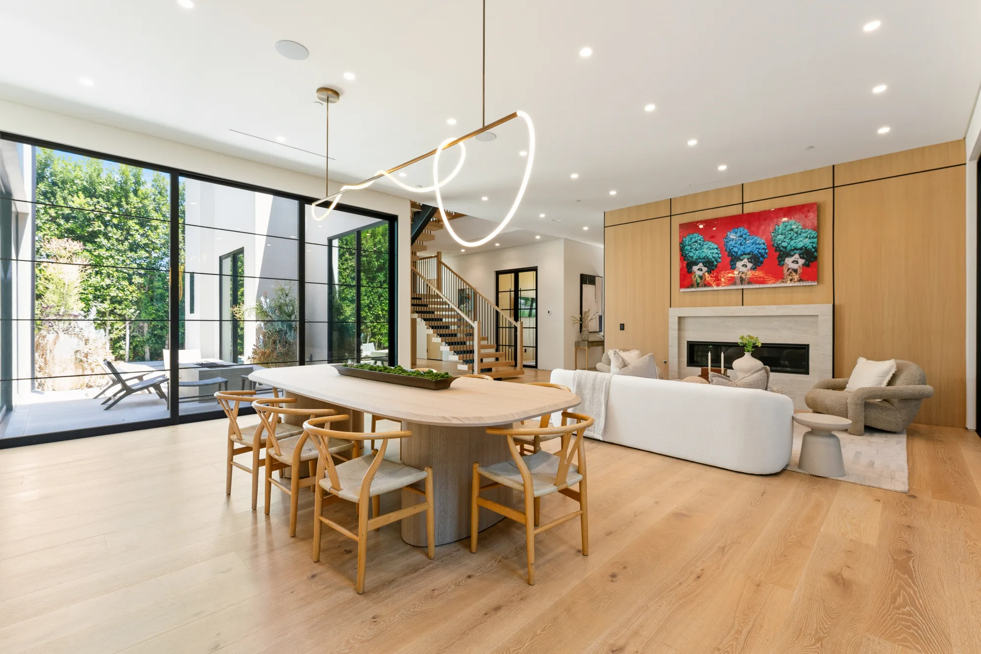 Dining and seating area viewed from the terrace side, stairs and fireplace lounge beyond