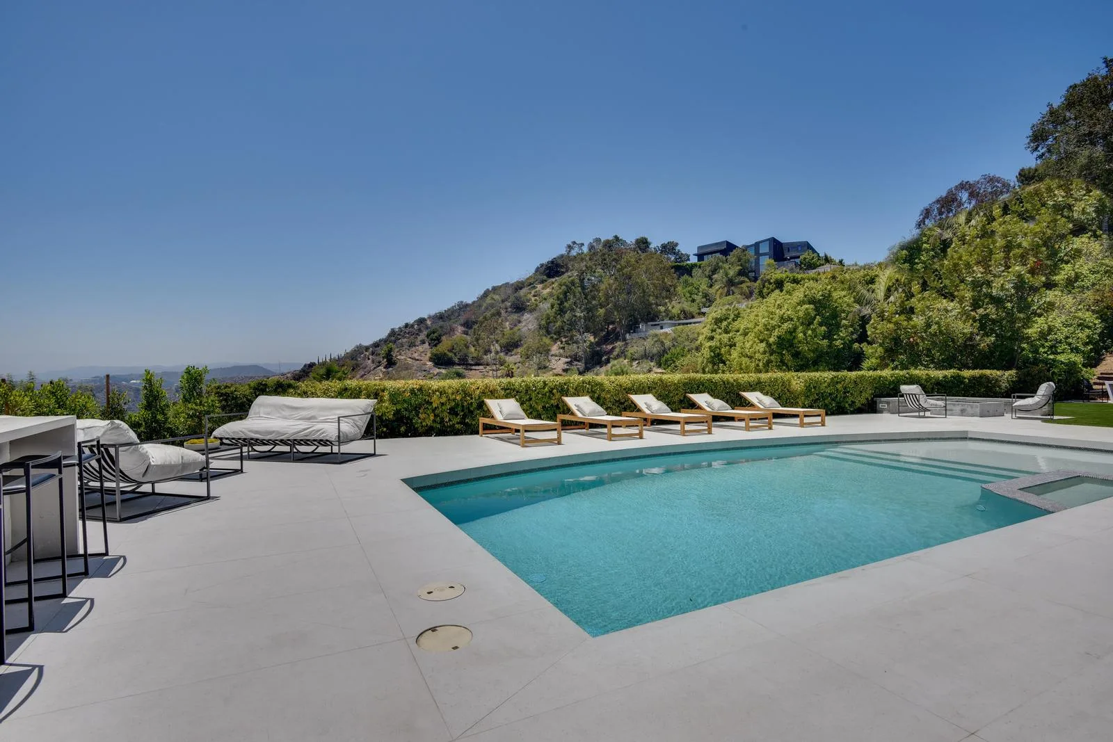 Pool terrace looking out to the canyon ridge and a neighbouring hillside home above Beverly Hills