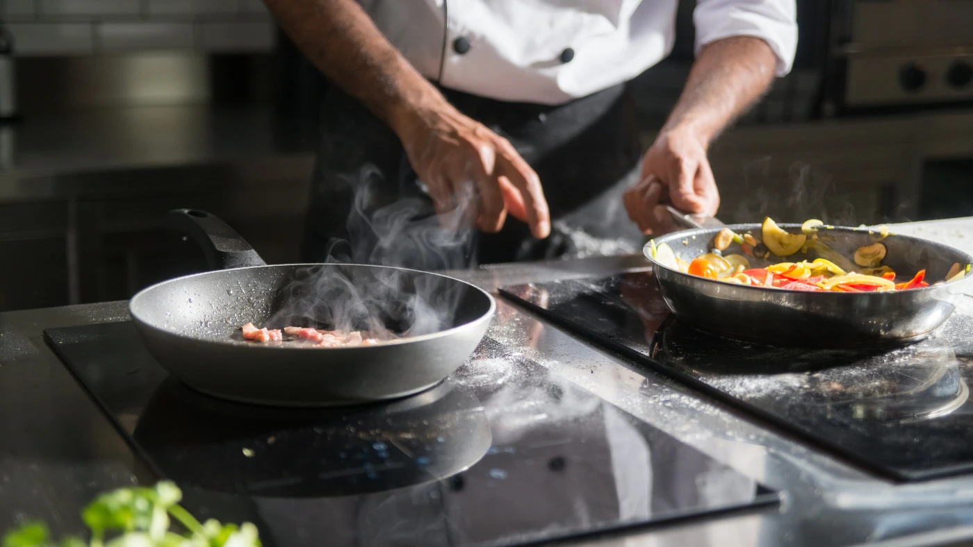 Private chef preparing fresh vegetables in a villa kitchen during an in-residence dining experience.