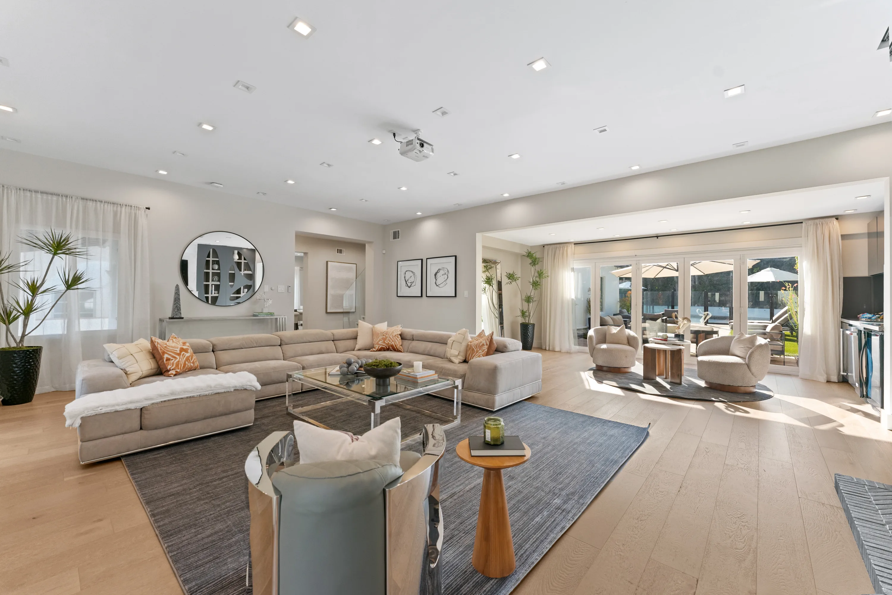 Bright, open-concept living room at Rodeo Villa, a luxury Beverly Hills vacation rental featuring modern furnishings, elegant interiors, and poolside views.