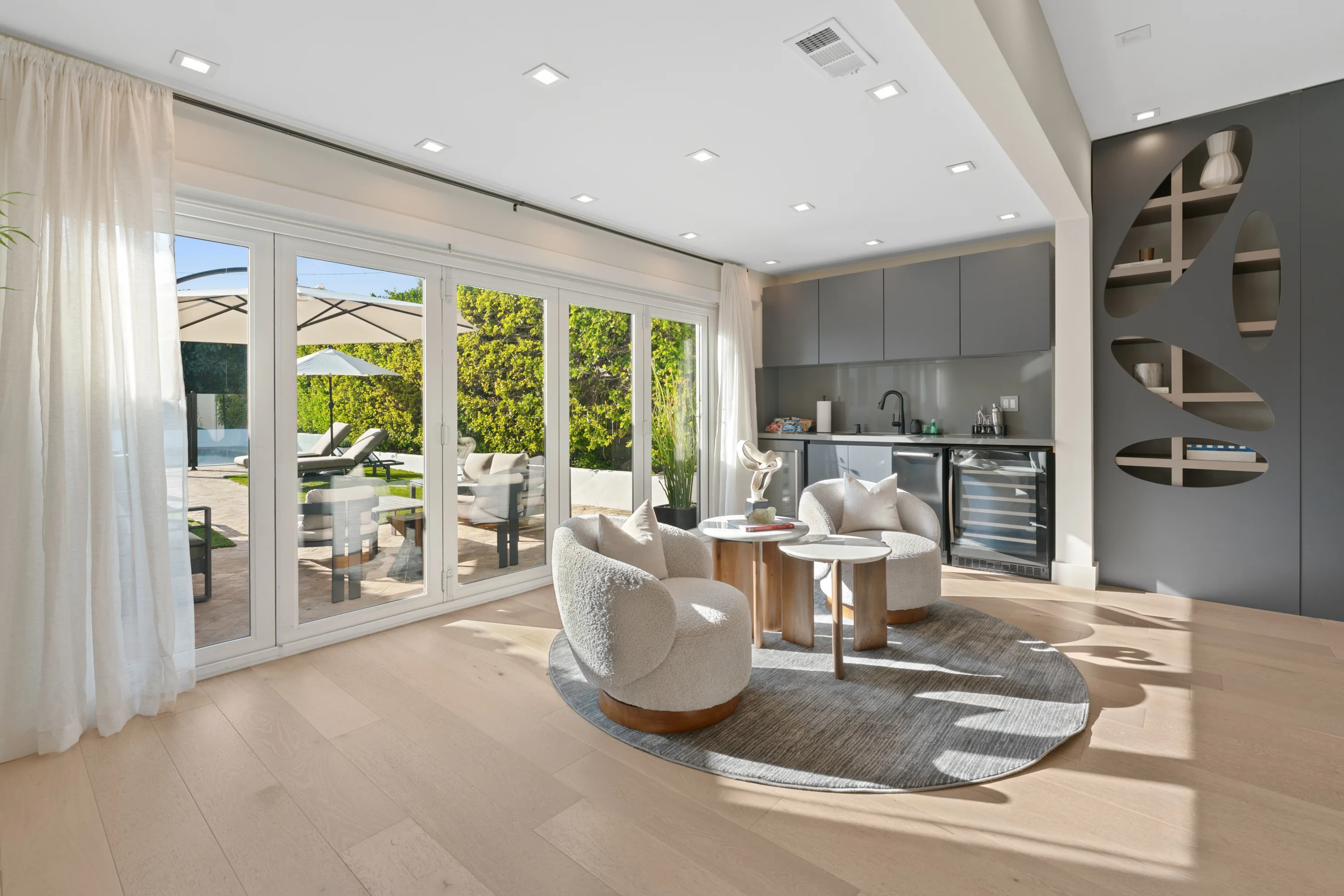 Bright, open-concept living room at Rodeo Villa, a luxury Beverly Hills vacation rental featuring modern furnishings, elegant interiors, and poolside views.