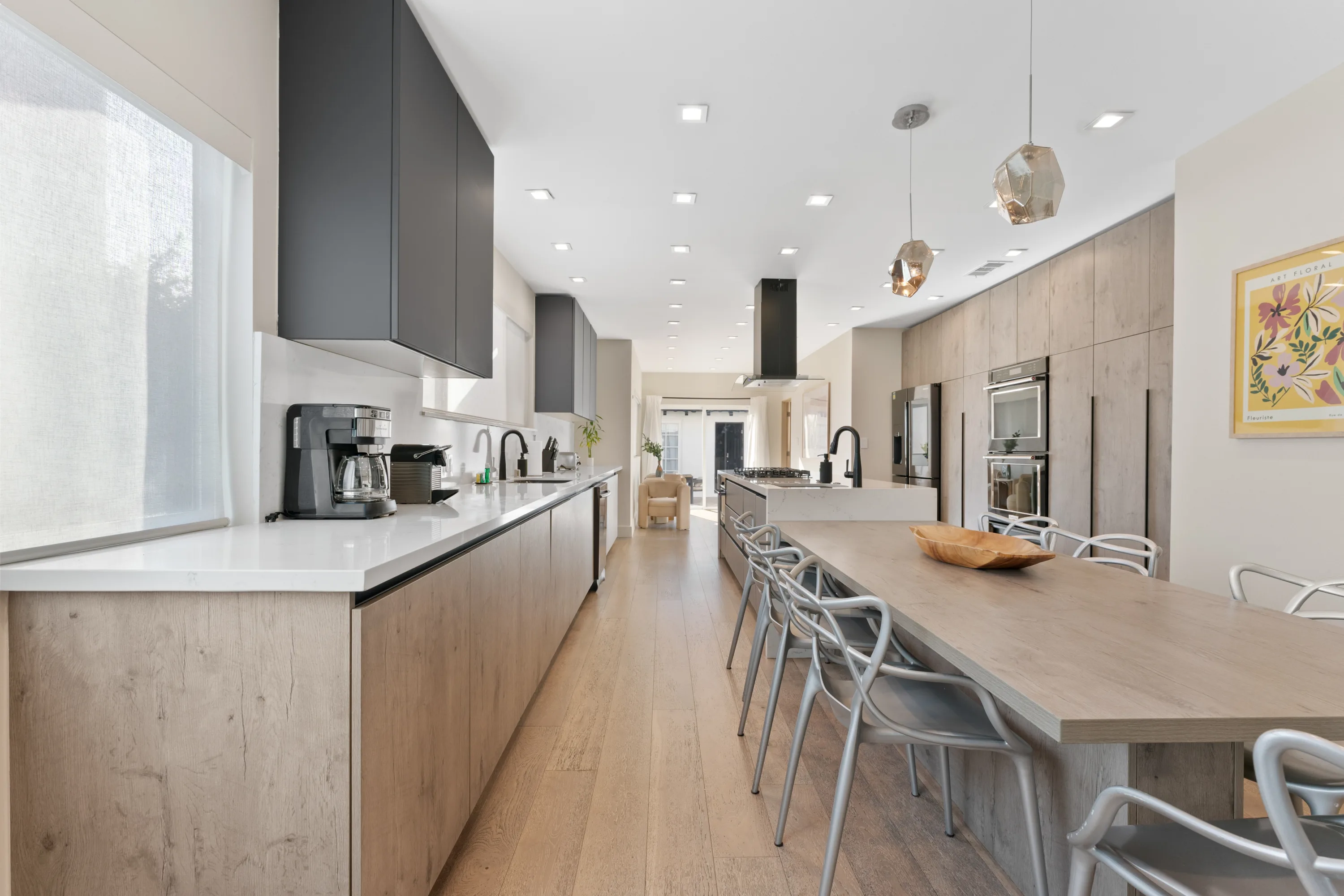 Modern chef's kitchen at Rodeo Villa, a luxury Beverly Hills vacation rental featuring a spacious marble island, premium appliances, and sleek cabinetry.